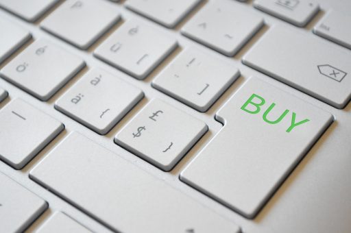 Persoon die een aankoop afrondt in een webshop op een laptop